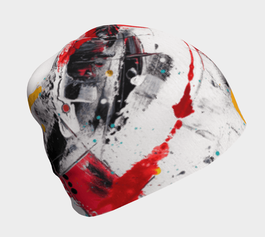 Art abstrait éclaboussé blanc et rouge sur une tuque grise, vue de côté.