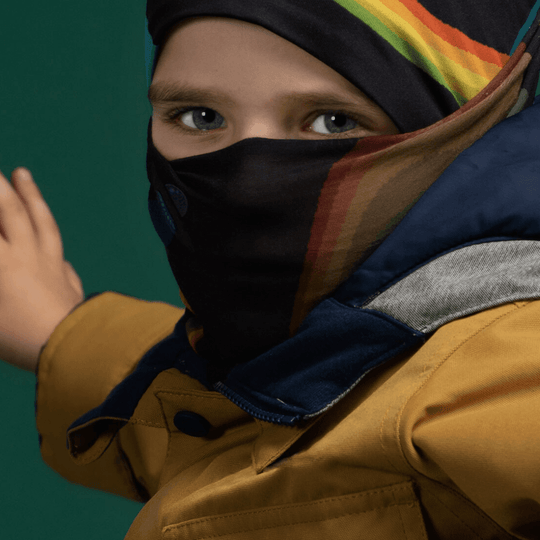 Close-up of a child wearing the Flying Saucers neck gaiter as a face covering.