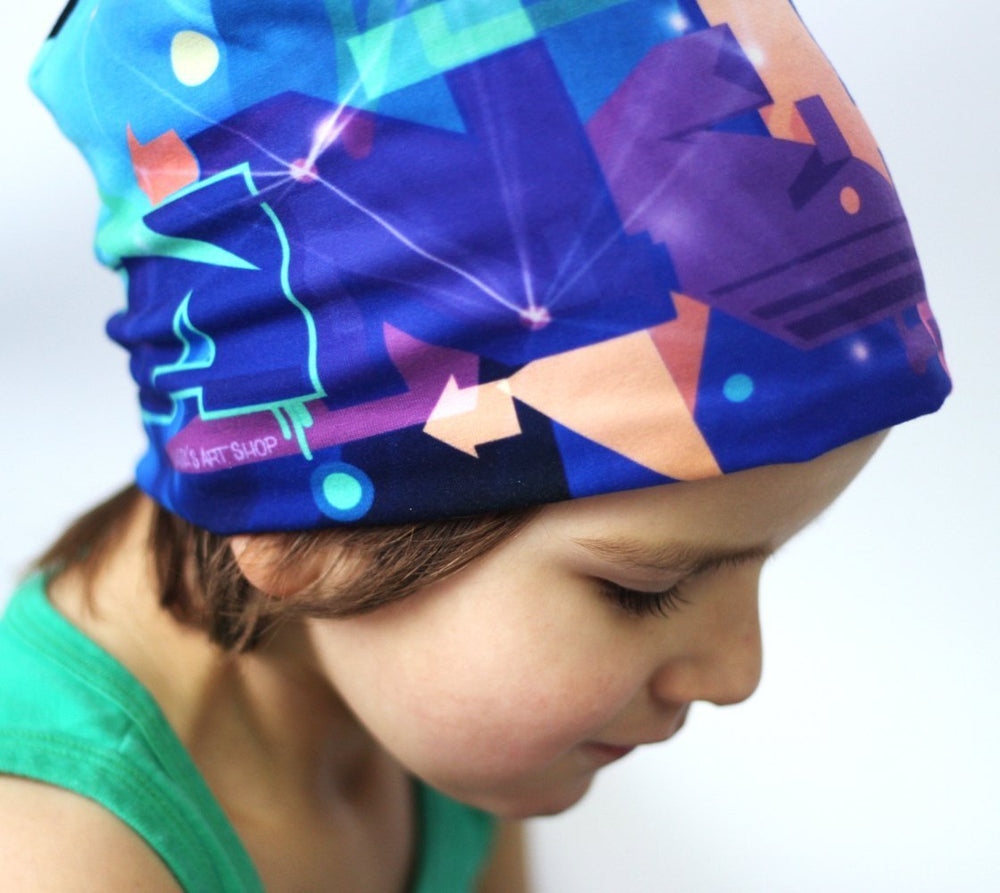 Un enfant portant la tuque colorée Galaxie, tirée sur son front.