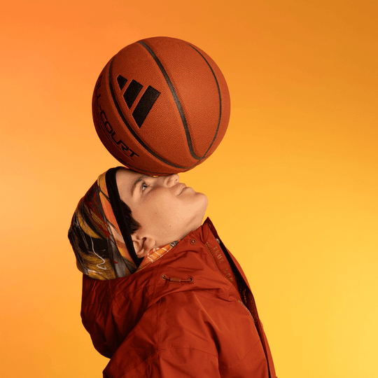 Person wearing the Le Coeur Beanie with a basketball balanced on their head.