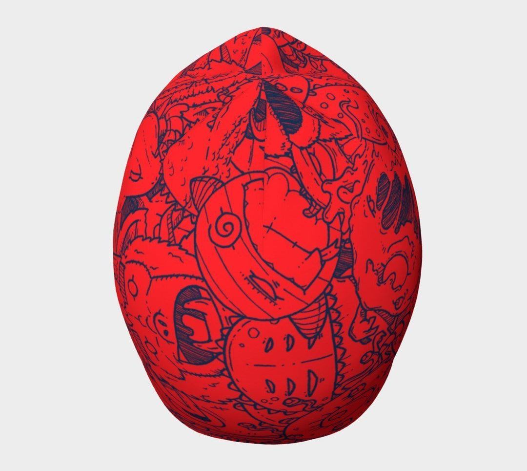 Tuque rouge avec des gribouillis de monstres bleus, vue de dessus.