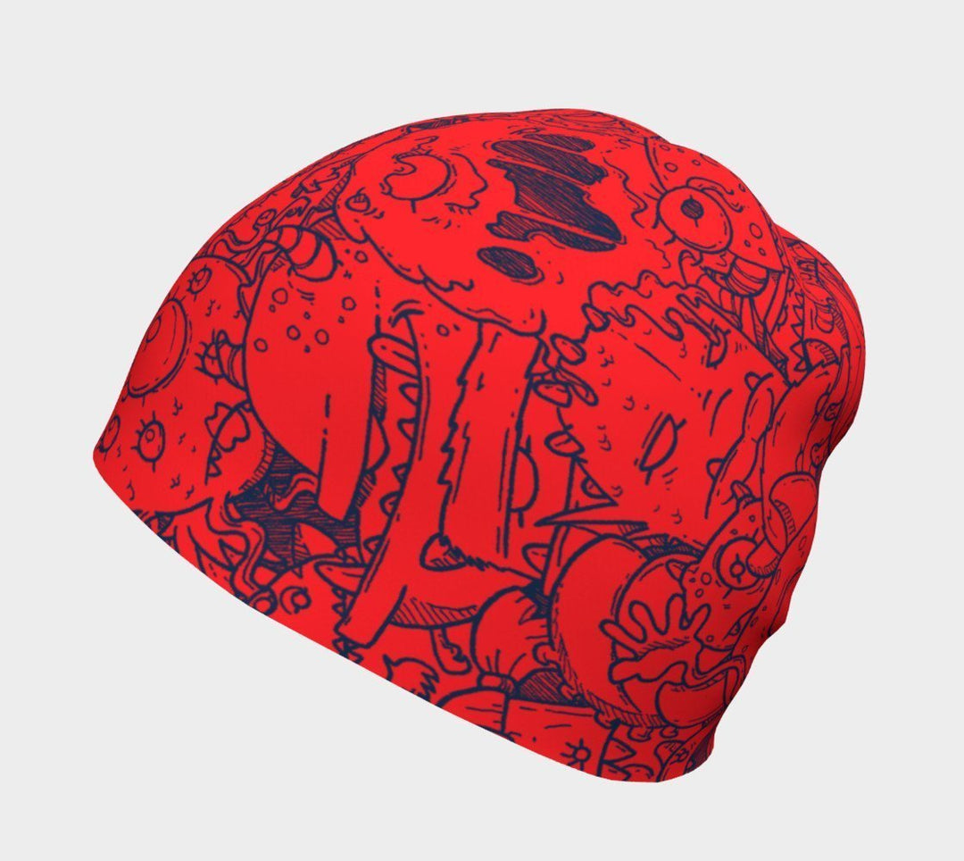 Gros plan de la tuque rouge avec des gribouillis de monstres bleus.