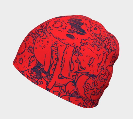 Gros plan de la tuque rouge avec des gribouillis de monstres bleus.