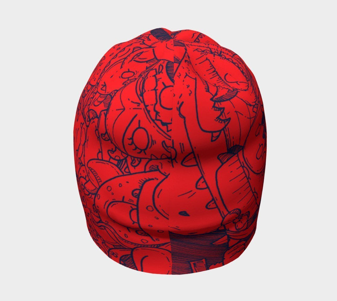 Tuque rouge avec des gribouillis de monstres bleus, vue de côté.