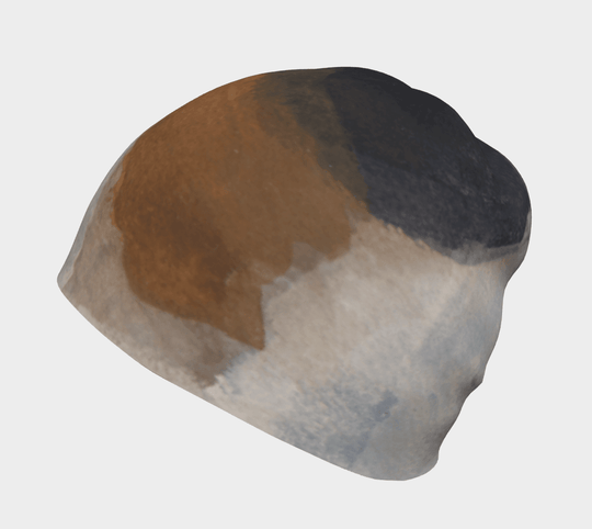 Side view of a relaxed fit beanie displaying abstract art in shades of brown, white, and black.