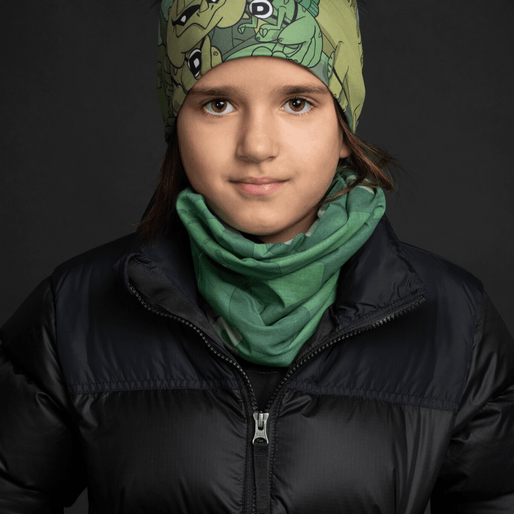 Young person wearing a black puffer jacket, with a green graphic print tube scarf around their neck.
