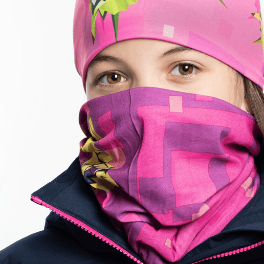 Woman wearing a pink neck gaiter with a geometric butterfly print, pulled up over her nose and mouth.