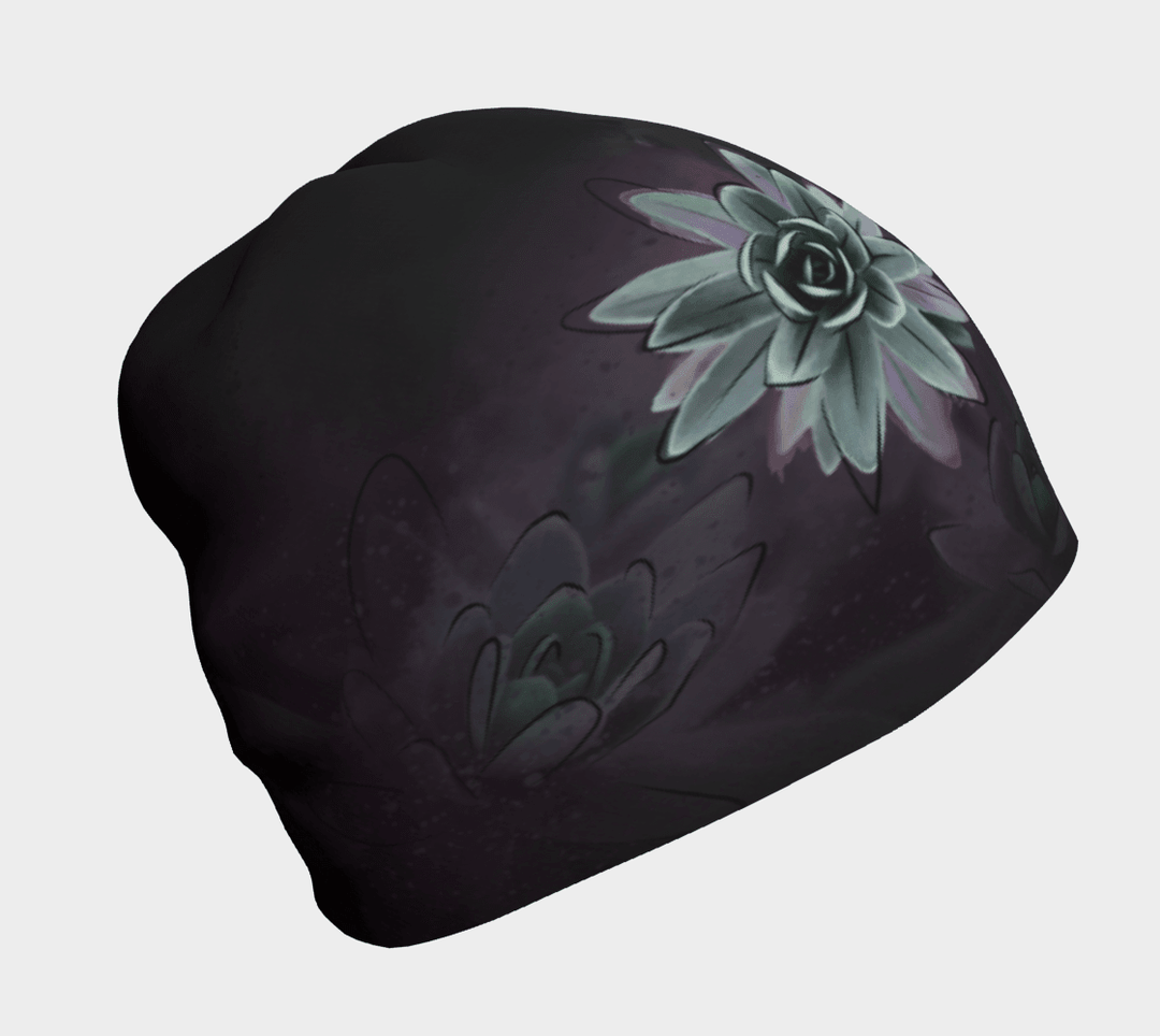Tuque noire avec un gros plan graphique d'une fleur de succulente vert pâle sur fond sombre et délavé.