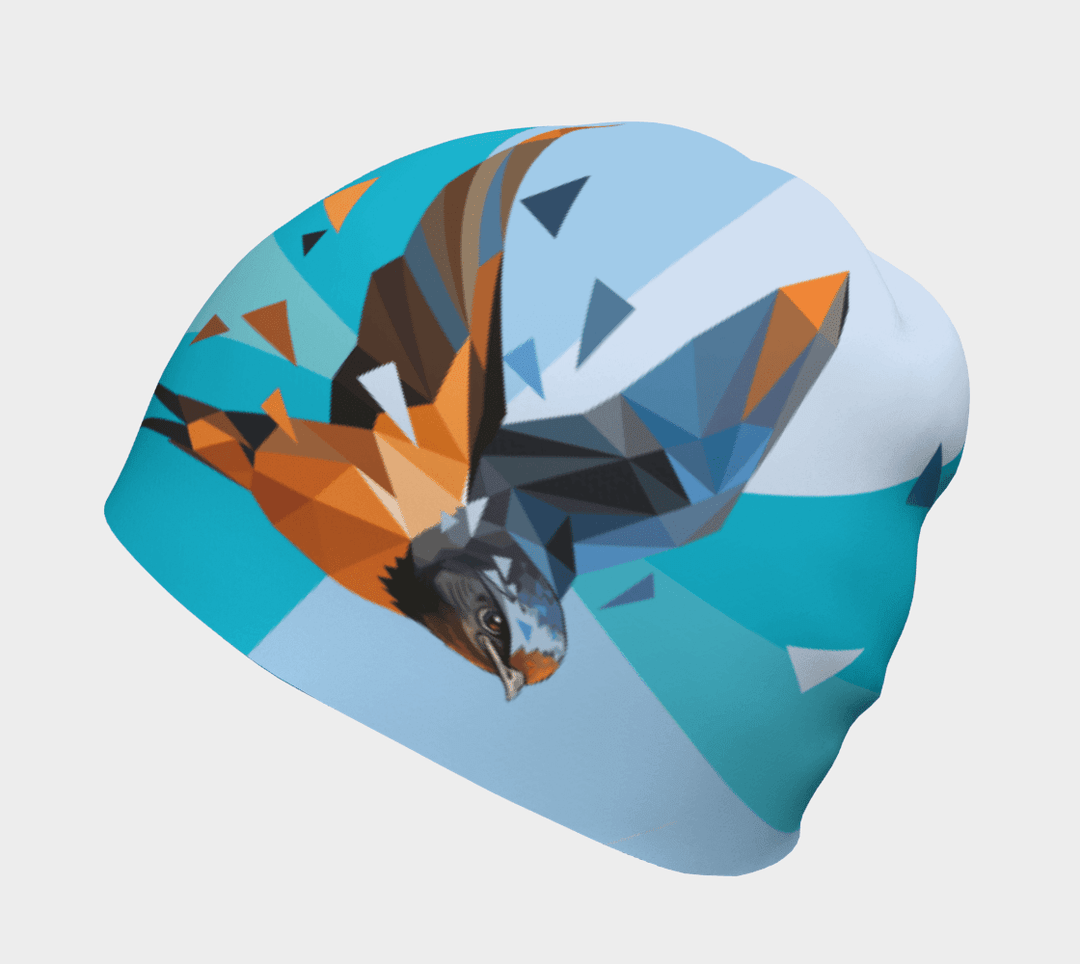 Une hirondelle stylisée en vol orne une tuque bleu pâle sur fond de formes géométriques abstraites.