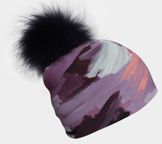 Tuque Tulipes montrant un art abstrait pastel et un pompon noir moelleux.