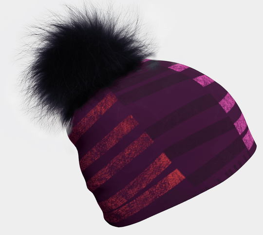 Tuque pour femme rayée violette et rose avec un grand pompon noir en fausse fourrure.