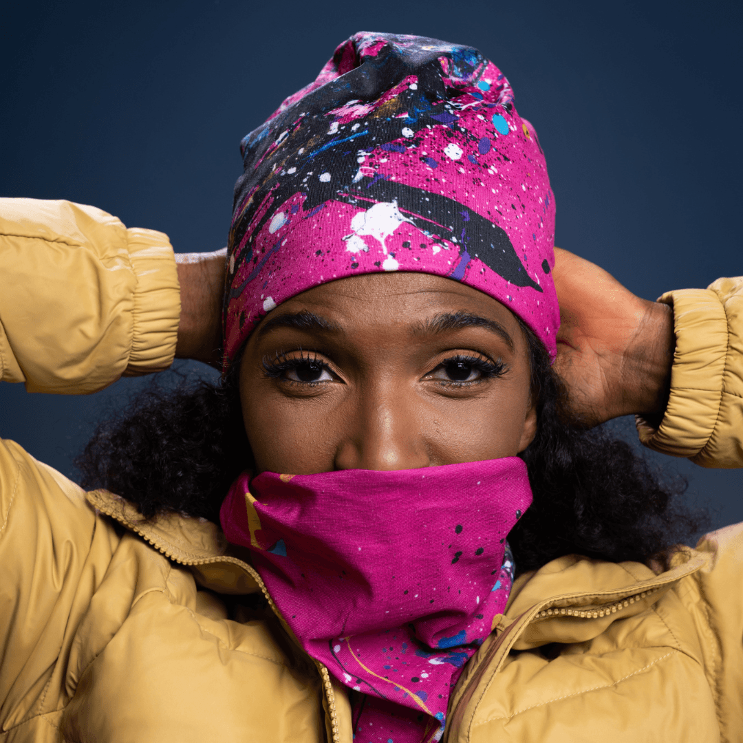 Woman wearing the pink abstract print tube pulled up as a face covering.