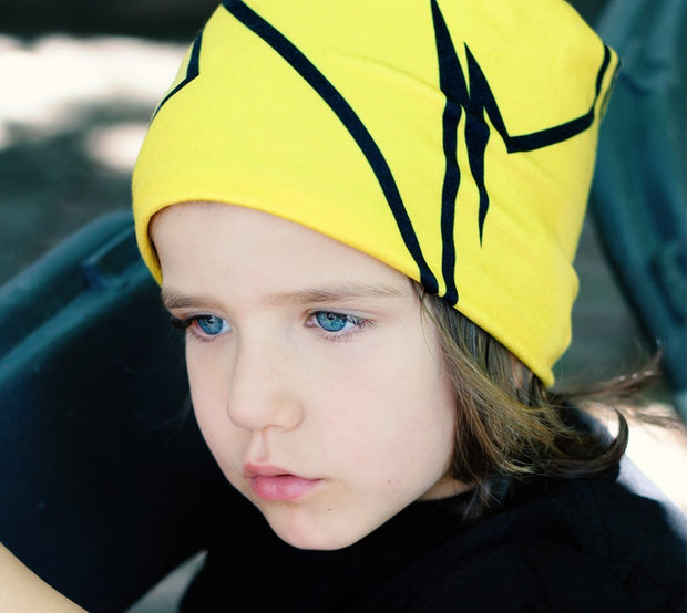 Child wearing Lalita's Art Shop Broken Line Grow-with-me beanie. 