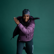 Woman running with beautiful beanie hat with flowers design and black Pompon. The yoga bamboo beanie is design by Claire Anghinolphi