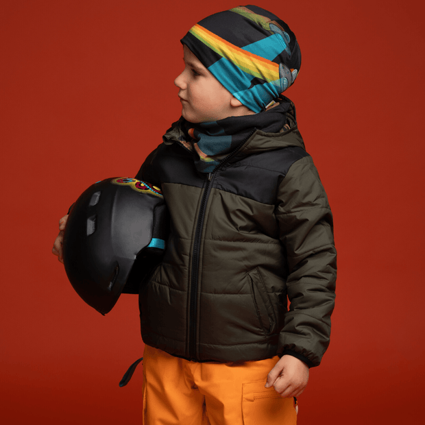 Young buoy wearing black and turquoise toque as a under helmet. 