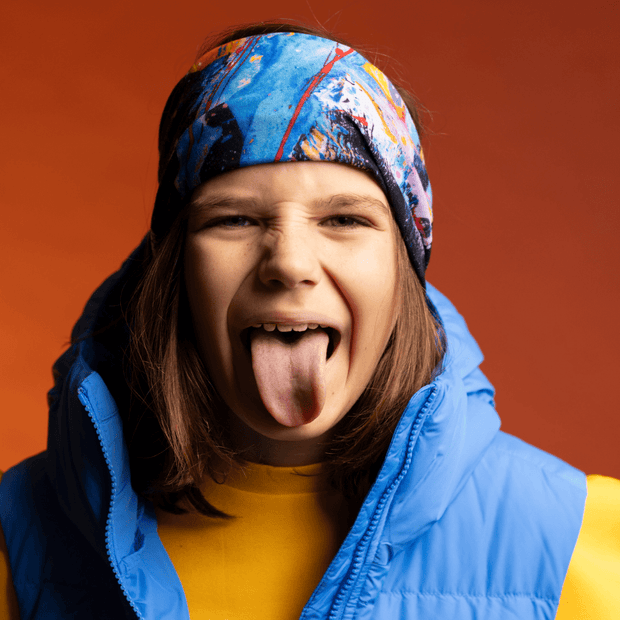 Boy making a funny face and wearing Megane Fortin's Matrix multifunctional tube as headband for the Lalita's ArtShop 24 collection