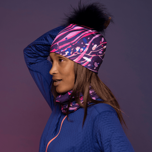 Woman wearing the Magenta Owl Pompom beanie with assorted multifunctional tube for Lalita's Art Shop 