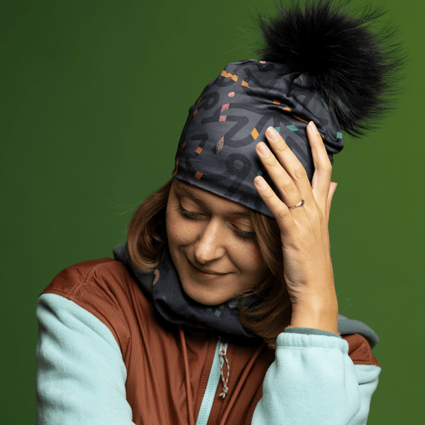 Women wearing the Symetrick Gray and Black Pompom Sport Beanie from Lalita's Art Shop