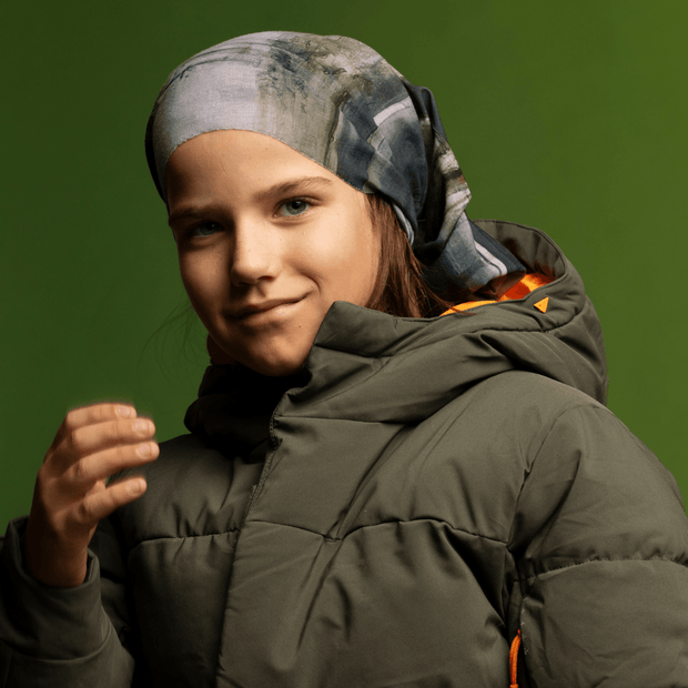 Young boy wearing the Gray and Green Wall multifunctional bandana by Elise Charette for the Lalita's Art Shop 24 collection