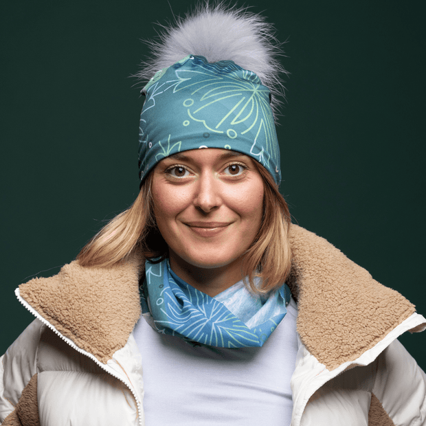 Young woman wearing the Blue Green multifunctional tube with assorted pompom beanie by Valery Goulet for Lalita's Art Shop