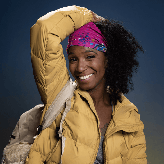 Woman waring the multifunctional tube as a bandana / hairband. 