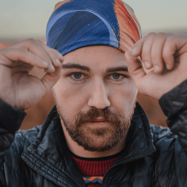 Man wearing the Yellow and Blue hat designed by the street artist Ankhone. This all season hat is very colorful and will be perfect for all sports activities.